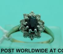 A 9ct gold ring set with an oval sapphire surrounded by diamonds (size O)