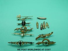 A yellow metal stick pin marked 10k, two 9ct gold brooches, one set with a garnet,
