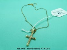 An 18ct gold cross pendant set with diamonds on an 18ct gold chain (7.