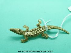 A 9ct gold brooch in the form of crocodile with ruby eyes (5.