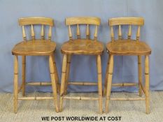 Three wooden bar/kitchen stools