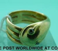 A Victorian yellow metal ring formed as a snake set with diamond eyes (12.