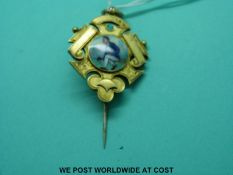 A silver gilt shield stock pin set with an enamel centre depicting a bowling scene