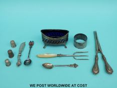 A hallmarked silver blue glass lined open salt, length 9cm, three hallmarked silver thimbles,