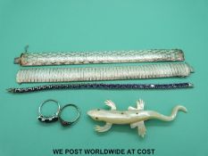 A collection of silver jewellery to include two bracelets, a bracelet set with amethysts,