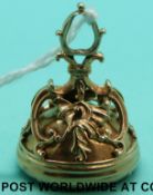 A 19thC gold intaglio fob with Latin inscription and a winged figure with a heart over a cauldron