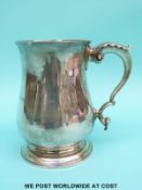 A Georgian hallmarked silver pint tankard of baluster form with acanthus leaf detail to handle,