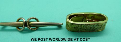 A yellow metal scarf clip with chased floral decoration and a yellow metal brooch marked 9ct gold