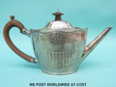 A George III hallmarked silver teapot with half ribbed and bright cut decoration,