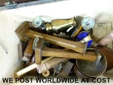 A quantity of wooden brass items in a trunk including candlesticks,