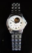 Frederique Constant wristwatch with luminous hands and markers, visible escapement and white face,