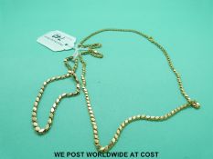 A yellow metal necklace and bracelet made up of oval links (12.