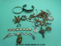 A hallmarked silver bangle with engraved chased decoration, a pewter bangle,