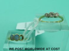 A yellow metal ring marked 18ct set with three diamonds in a platinum setting (size N) and an 18ct