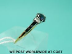 An 18ct gold ring set with a sapphire flanked by diamonds in a platinum setting (size N)