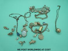 Two silver charm bracelets, three silver necklaces and silver charms.