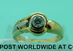 An 18ct gold ring set with a brilliant cut diamond of approximately 0.