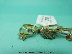 Two silver gilt rings set with diamonds in a twist setting,