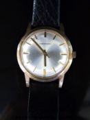 Garrard 9ct gold gentleman's wristwatch with gold hands and baton markers and engine turned face,