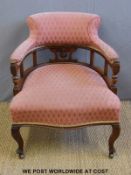 A 19th century upholstered mahogany serpentine fronted tub chair raised on four cabriole legs and