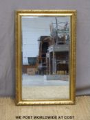A bevelled glass mirror with decorative gilt frame (49 x 77cm)