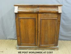 A 19thC oak chest of drawers having cupboard doors opening to reveal four graduated drawers the top