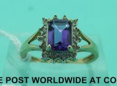 A 9ct gold ring set with an emerald cut amethyst surrounded by diamonds (size N)