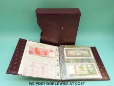 An album of uncirculated world bank notes to include Ghana, Argentina, Iraq, Peru, Zambia,