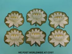 Six possible table place settings with silk backing and finely embroidered detail of lily pads