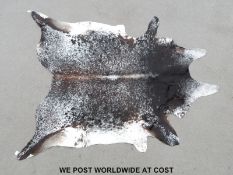 A large cowhide rug (length 250cm,