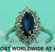 An 18ct white gold ring set with a marquise cut sapphire surrounded by diamonds (size U)