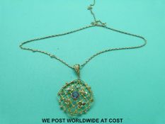 An Edwardian pendant marked 9ct gold set with an amethyst to the centre and seed pearls on a