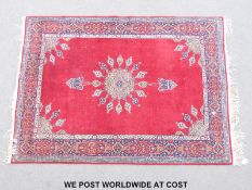 An Afghan rug with central starburst design (180 x 127cm)