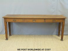 A large Art Nouveau oak hall table with three drawers,
