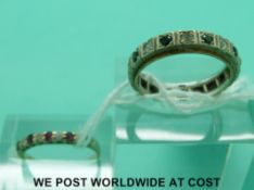 A 9ct gold ring and a white metal eternity ring (size M)