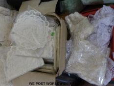Four boxes containing a large quantity of table runners and similar furniture covers etc.