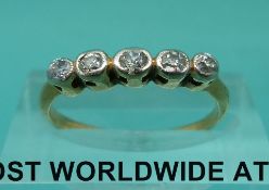 A yellow metal ring marked 18ct set with five diamonds (1.