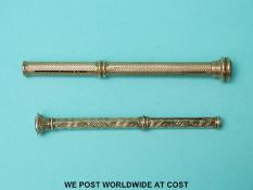 Two yellow metal pencils with hardstone finials, length of longer example 8.