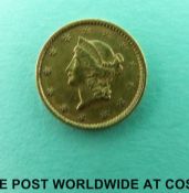 An American gold dollar 1853 1.