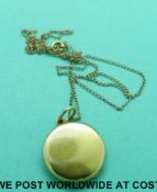 An 1862 yellow metal locket and chain (4.