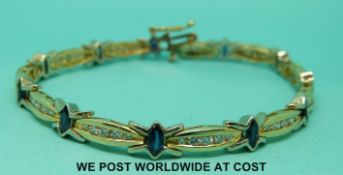 A yellow metal bracelet marked 14k set with marquise cut sapphires and round cut diamonds