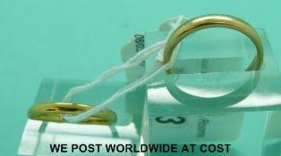 A 22ct gold wedding ring (2.6g, size N) and a yellow metal wedding ring (4.