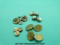 A pair of 9ct gold cufflinks (14.8g), three yellow metal studs (1.