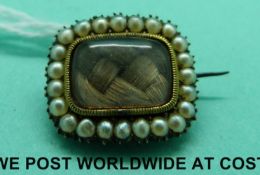 A Georgian/ Victorian mourning brooch set with pearls