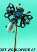 A French gold stick pin in the form of a fly with ruby eyes,