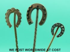 A Victorian stick pin in the form of a horseshoe set with rose cut diamonds and two further similar