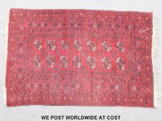 A Turkoman rug with central panel of fourteen Guls 187x127cm