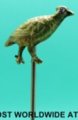 A Victorian yellow metal stick pin in the form of a grouse set with a ruby to the eye
