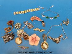 A collection of costume jewellery to include brooches, necklaces, an Art Deco necklace, Golly badge,