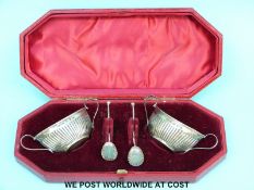 A cased pair of Victorian hallmarked silver salts with spoons,